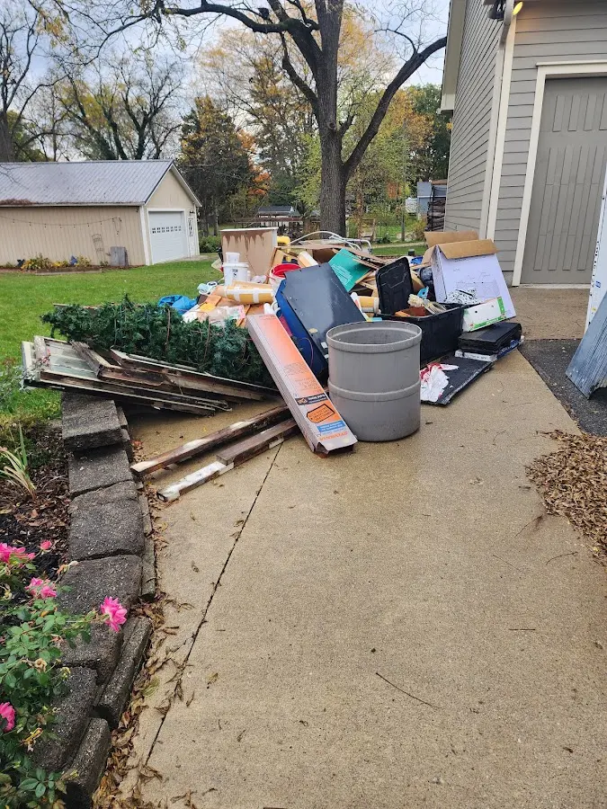 Dumpster being loaded with debris for 12 Yard Dumpster Rental in Elizabeth